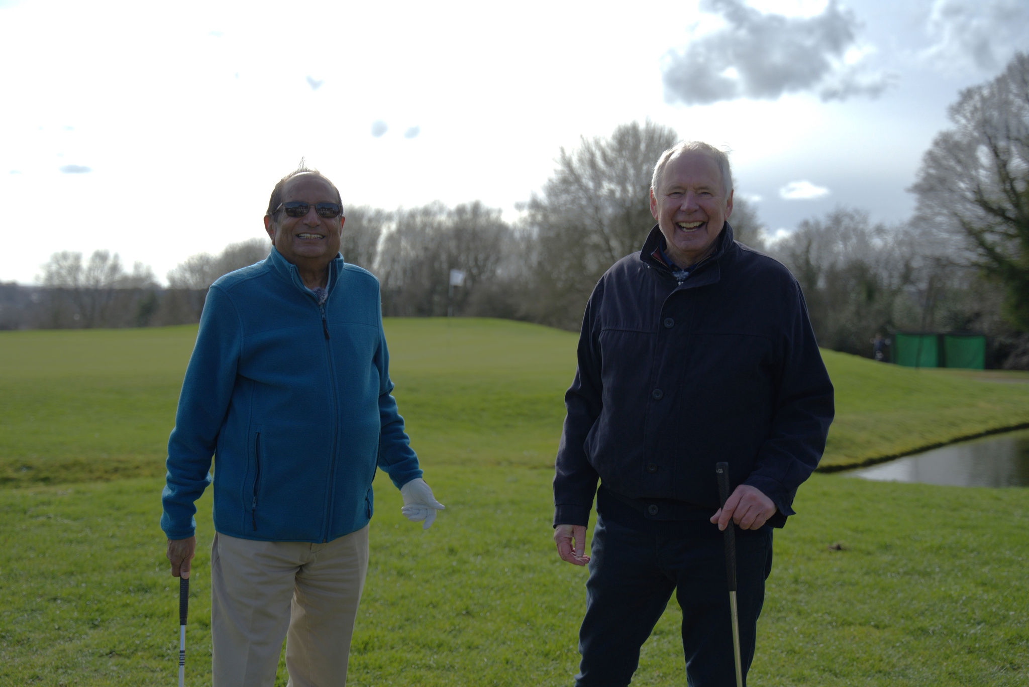 Podcast presenter Nick Owen on golf course with GenesisCare prostate cancer patient Kanty